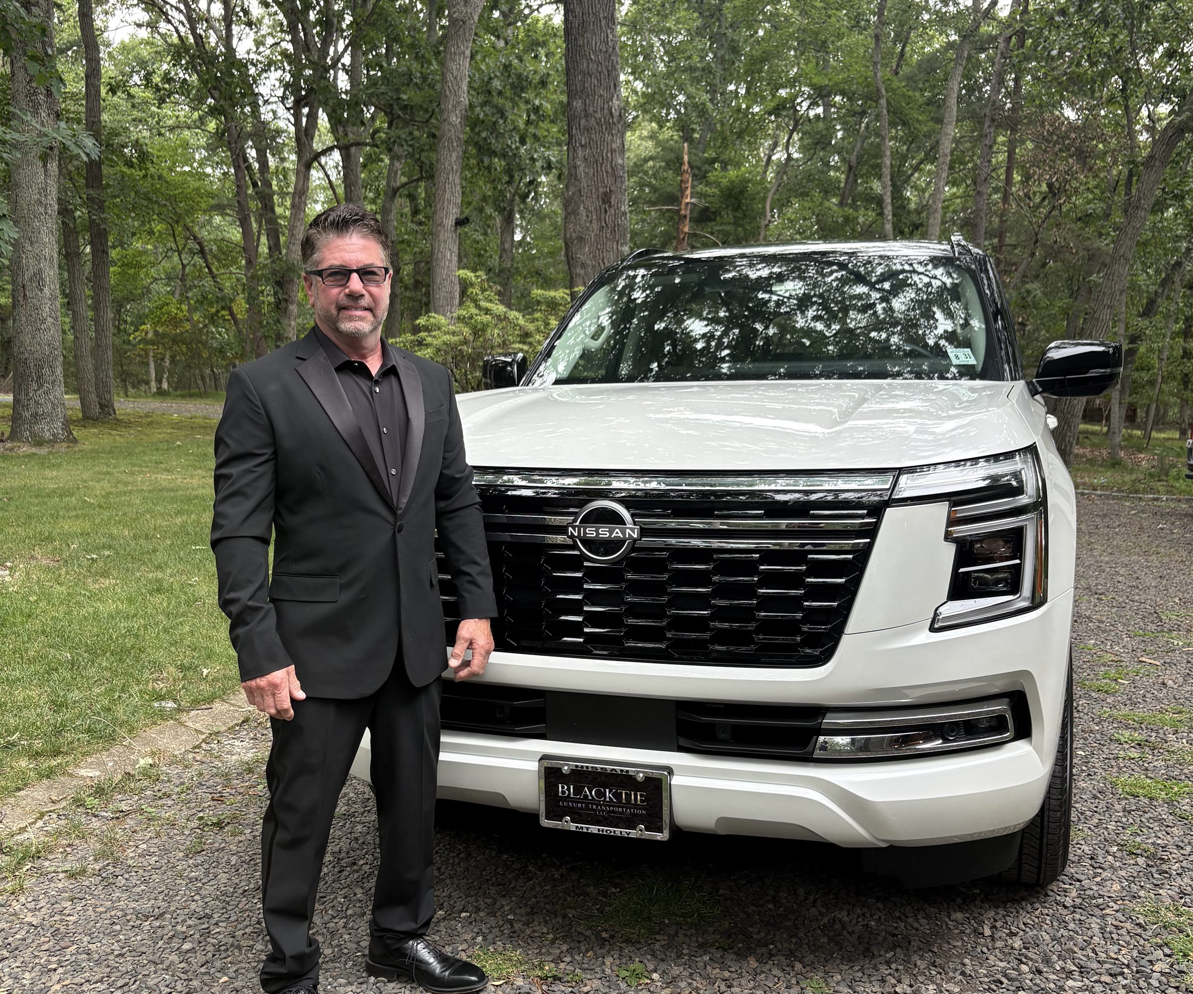 Antonio D’Armiento beside his white Nissan Armada Platinum